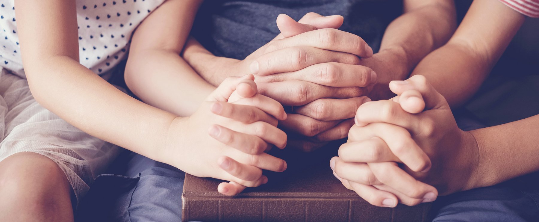 children praying with parent at home, family pray